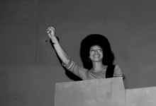 American political activist and academic Angela Davis raises her fist as she speaks at Glide Church, San Francisco, California, July 20, 1975. (Photo by Janet Fries/Getty Images)