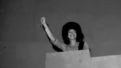 American political activist and academic Angela Davis raises her fist as she speaks at Glide Church, San Francisco, California, July 20, 1975. (Photo by Janet Fries/Getty Images)
